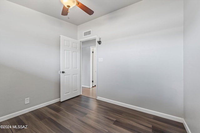 unfurnished room featuring dark hardwood / wood-style flooring and ceiling fan