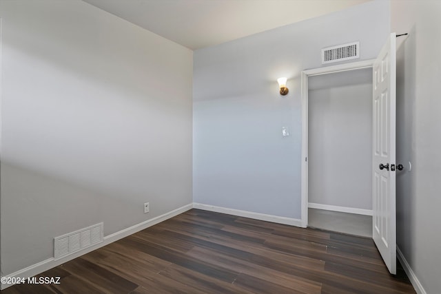 unfurnished room with dark hardwood / wood-style floors