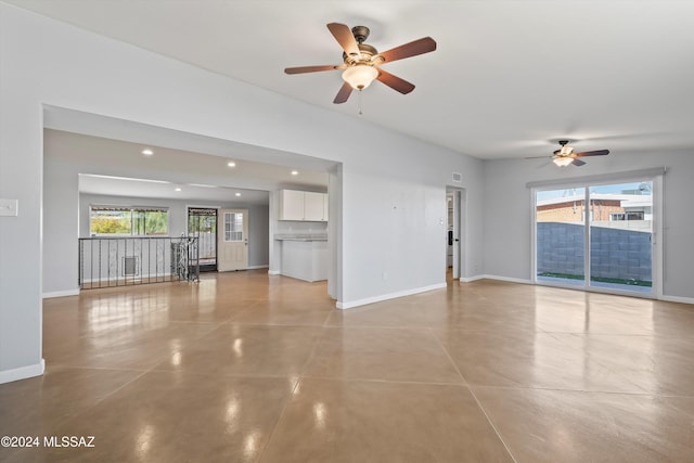 unfurnished living room featuring ceiling fan