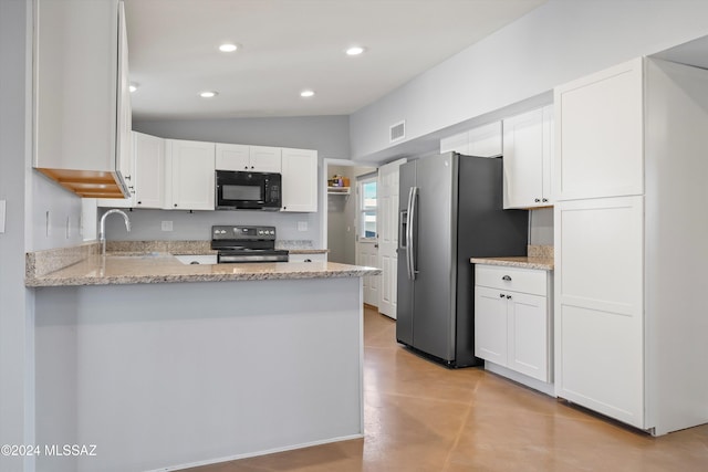 kitchen featuring lofted ceiling, white cabinets, sink, light stone countertops, and appliances with stainless steel finishes