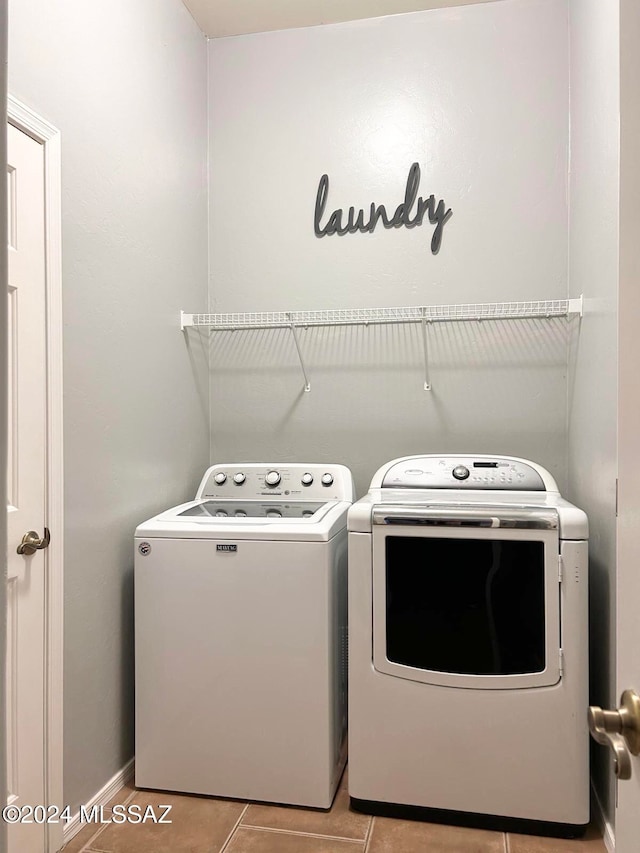 washroom with light tile patterned flooring and separate washer and dryer