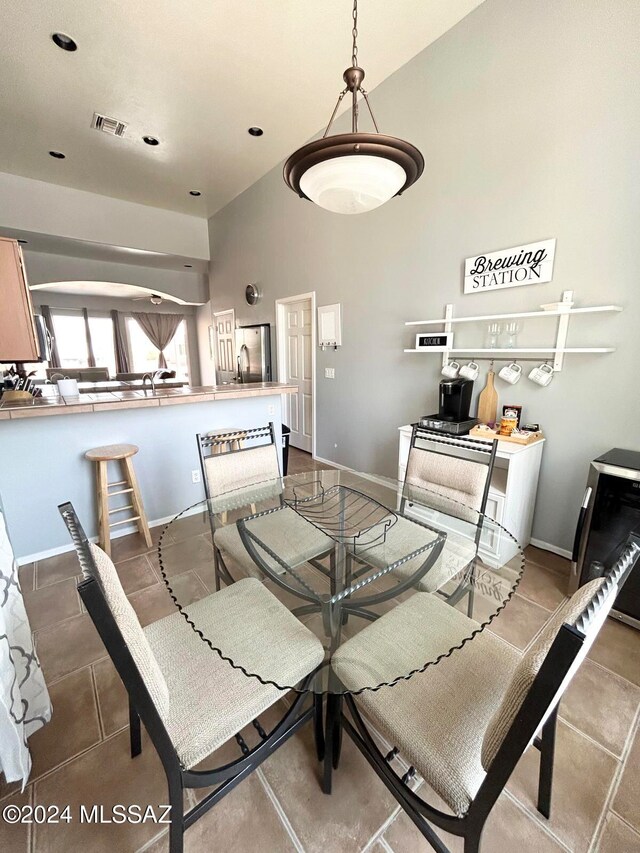 dining room with tile patterned flooring and lofted ceiling