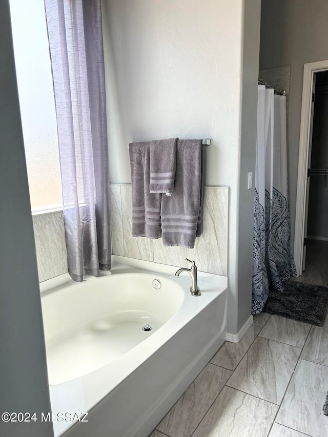 bathroom featuring shower with separate bathtub