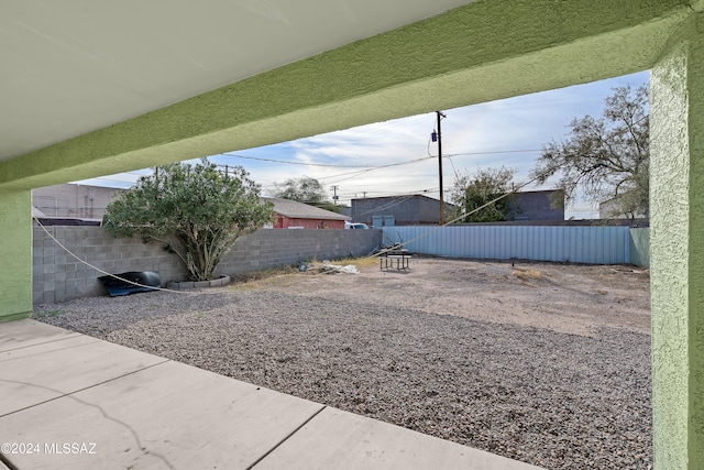 view of yard featuring a patio area and an outdoor fire pit