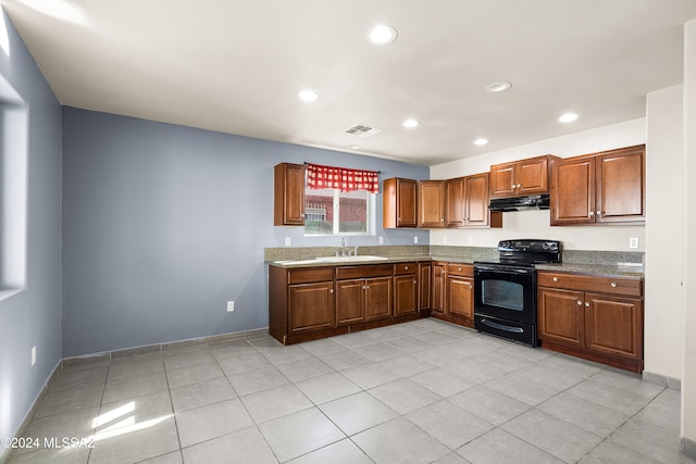 kitchen featuring electric range, sink, and light tile patterned flooring