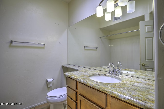 bathroom with vanity and toilet