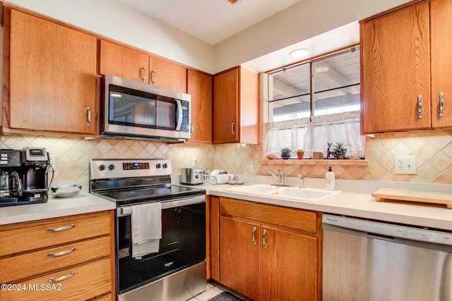 kitchen with backsplash, sink, and stainless steel appliances