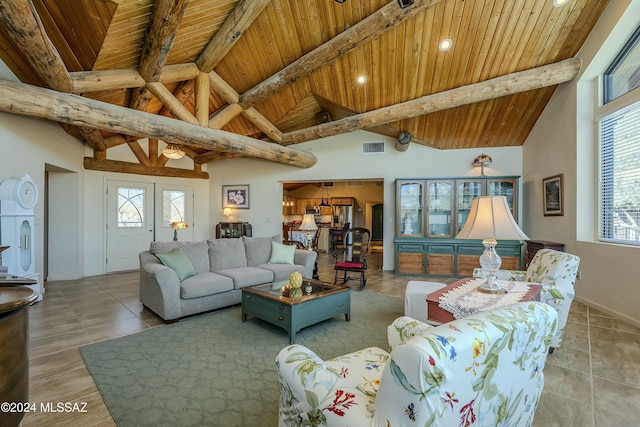 tiled living room featuring beamed ceiling, a healthy amount of sunlight, and wood ceiling