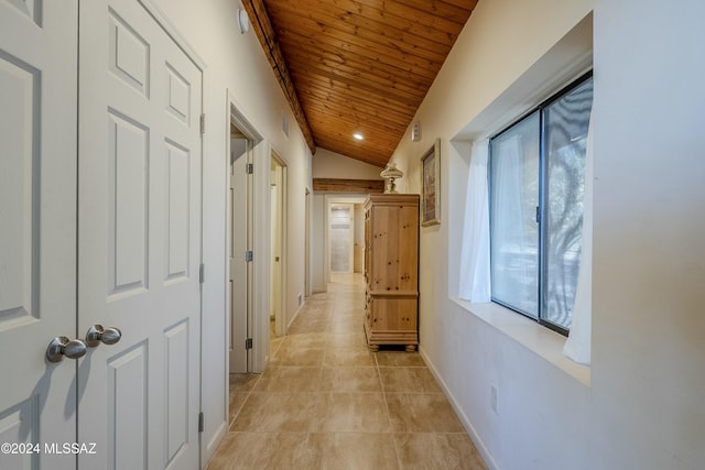 hall featuring light tile patterned floors, wood ceiling, and lofted ceiling