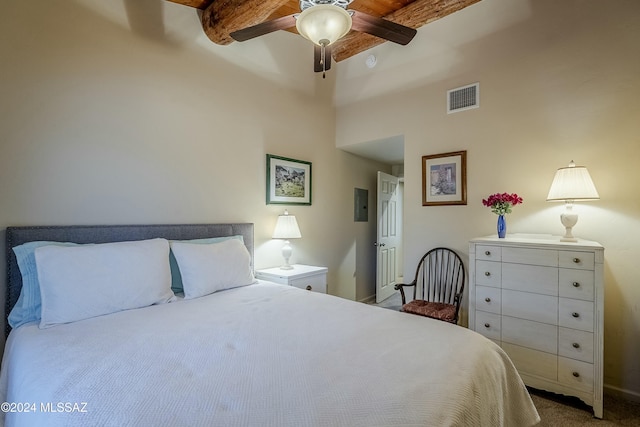 carpeted bedroom with beamed ceiling, ceiling fan, and a towering ceiling