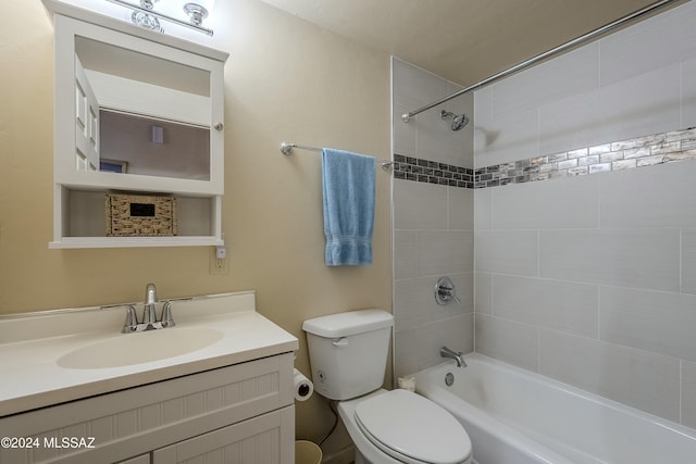 full bathroom featuring tiled shower / bath combo, toilet, and vanity