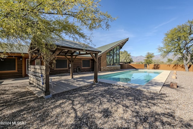 view of pool with a mountain view and a patio