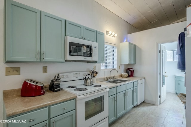 kitchen with wood ceiling, white appliances, sink, light tile patterned floors, and green cabinetry