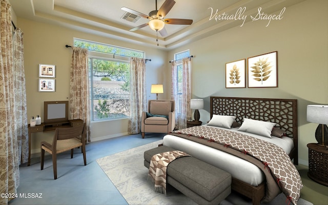 bedroom featuring a tray ceiling and ceiling fan