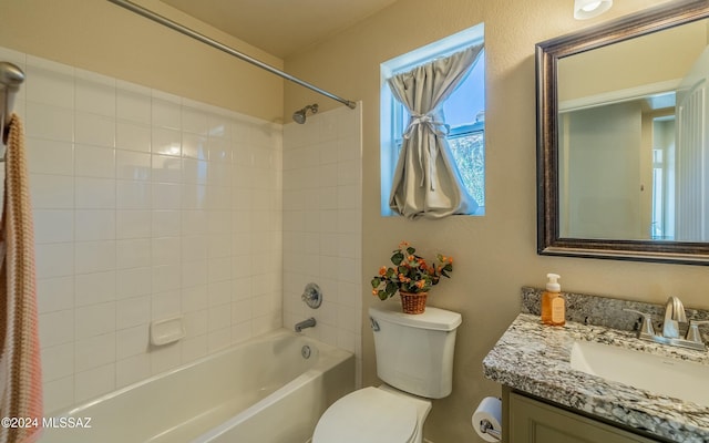 full bathroom with vanity, toilet, and tiled shower / bath combo