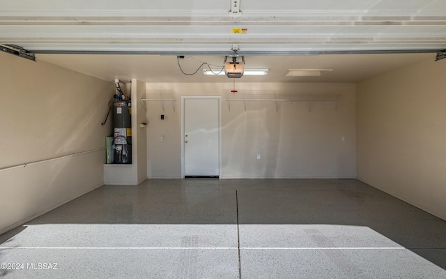 garage featuring water heater and a garage door opener