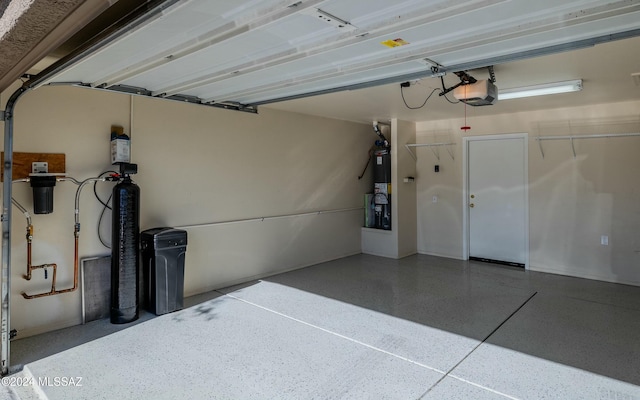 garage with secured water heater and a garage door opener