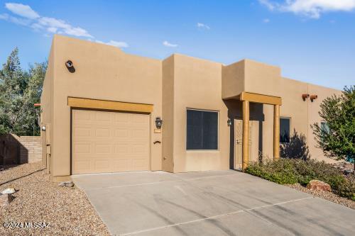 pueblo revival-style home with a garage