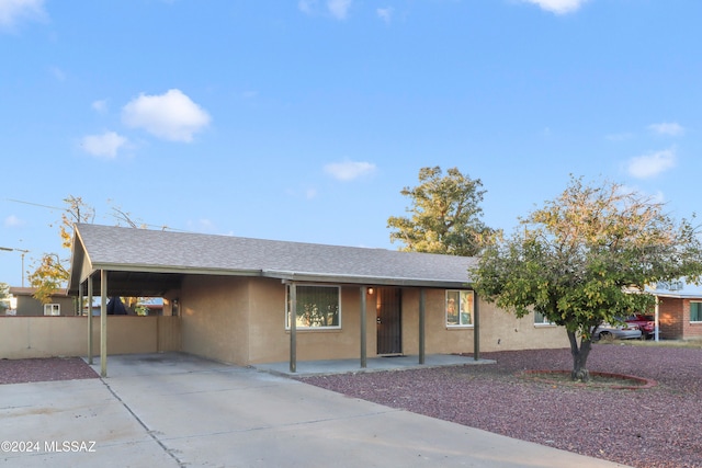 view of front of property featuring a carport