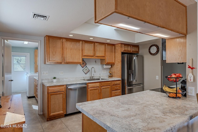 kitchen with sink, light tile patterned flooring, and stainless steel appliances