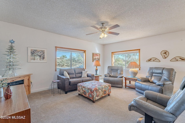 carpeted living room featuring a healthy amount of sunlight, a textured ceiling, and ceiling fan