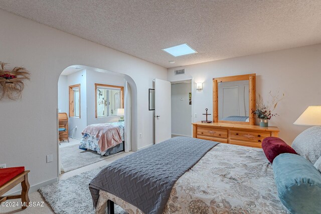 carpeted bedroom featuring a textured ceiling