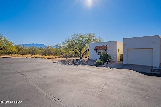 exterior space featuring a garage and a mountain view