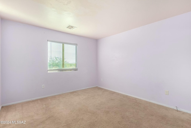 empty room with light colored carpet