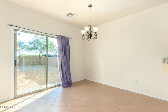 tiled empty room featuring a notable chandelier