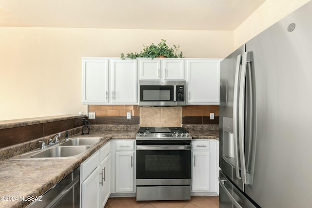 kitchen with white cabinets, backsplash, sink, and appliances with stainless steel finishes