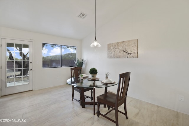 dining area featuring vaulted ceiling