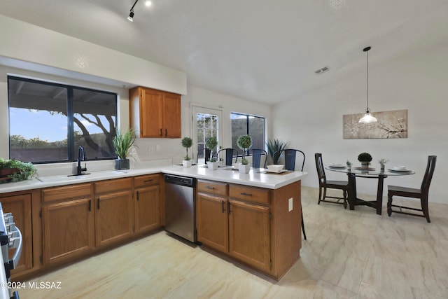 kitchen featuring kitchen peninsula, stainless steel dishwasher, vaulted ceiling, sink, and hanging light fixtures