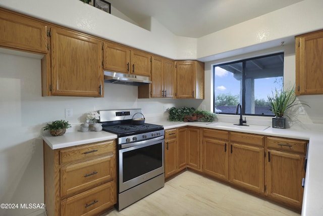 kitchen featuring sink, light hardwood / wood-style flooring, and stainless steel range with gas stovetop