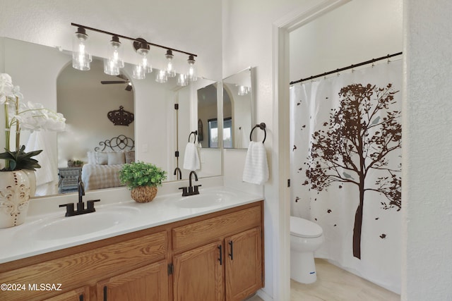 bathroom featuring vanity, toilet, and walk in shower