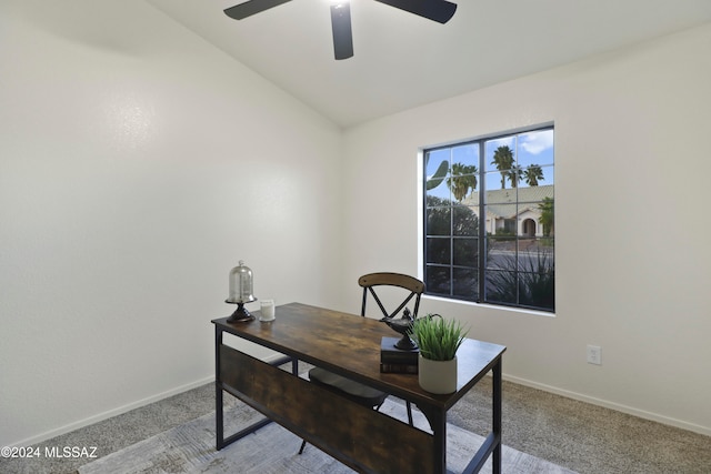 office area featuring ceiling fan, light carpet, and vaulted ceiling