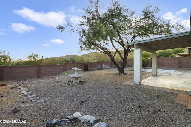 view of yard with a mountain view and a patio area