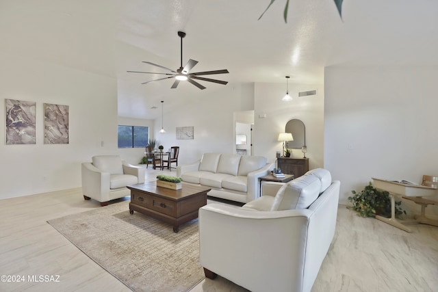 living room with ceiling fan, light hardwood / wood-style floors, and high vaulted ceiling