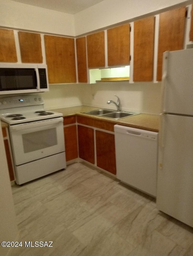 kitchen featuring white appliances and sink