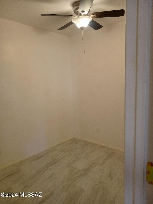 spare room featuring carpet flooring and ceiling fan