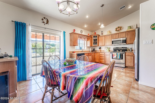 tiled dining room with an inviting chandelier, sink, and vaulted ceiling