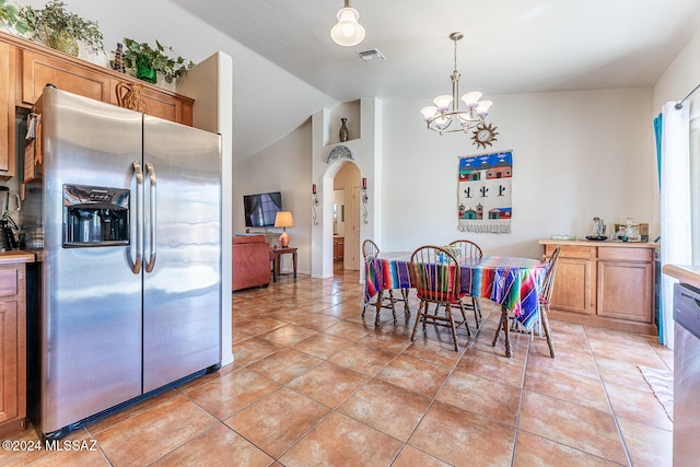 dining room featuring light tile patterned flooring, vaulted ceiling, and a notable chandelier