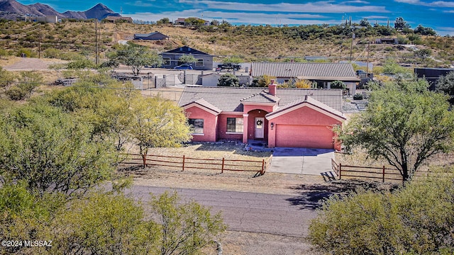 view of front of home featuring a mountain view and a garage