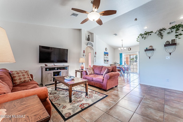 tiled living room featuring ceiling fan with notable chandelier and vaulted ceiling