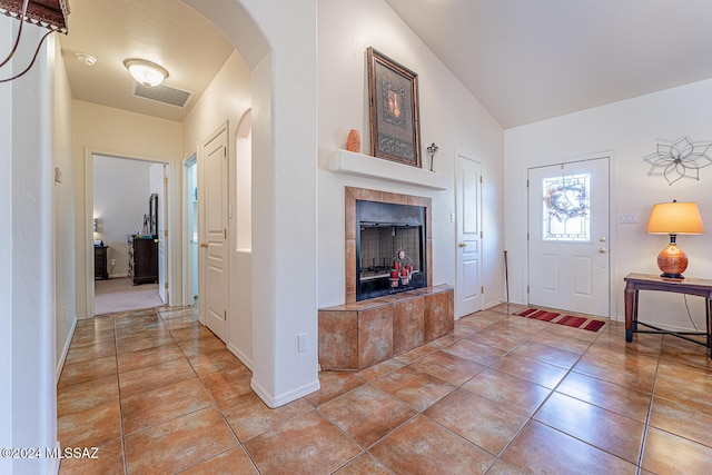 tiled entryway featuring a fireplace