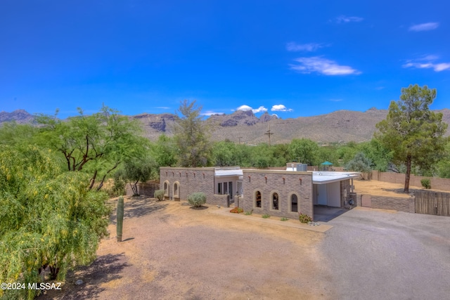 view of front of property with a mountain view and a carport