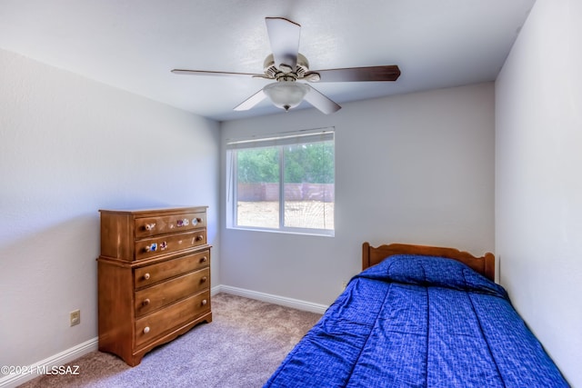 bedroom featuring light colored carpet and ceiling fan