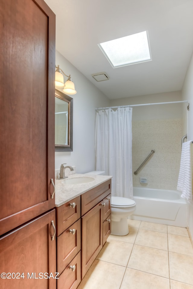 full bathroom featuring a skylight, tile patterned flooring, toilet, vanity, and shower / tub combo