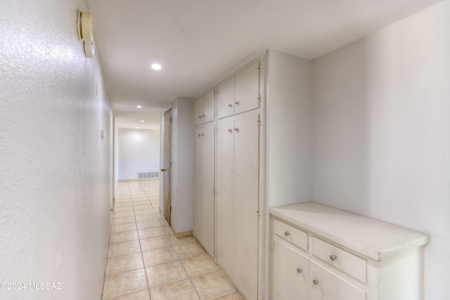 corridor featuring light tile patterned flooring