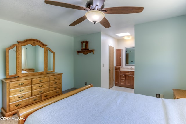 bedroom with ensuite bathroom and ceiling fan