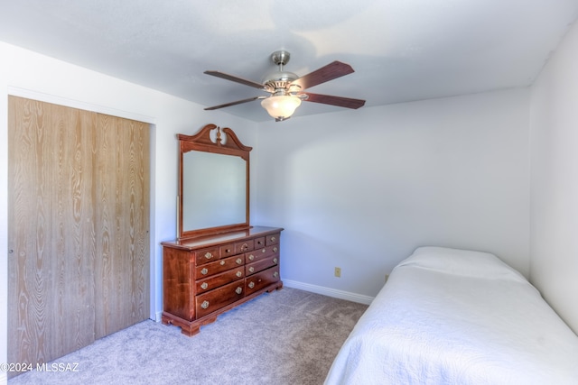 carpeted bedroom with a closet and ceiling fan